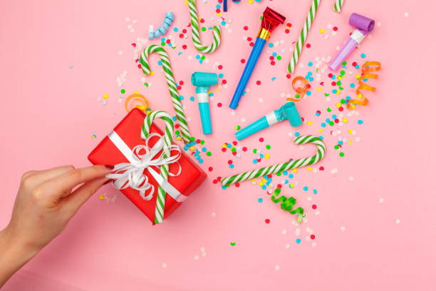 istock gift box with various party confetti, streamers and decoration 1427598596