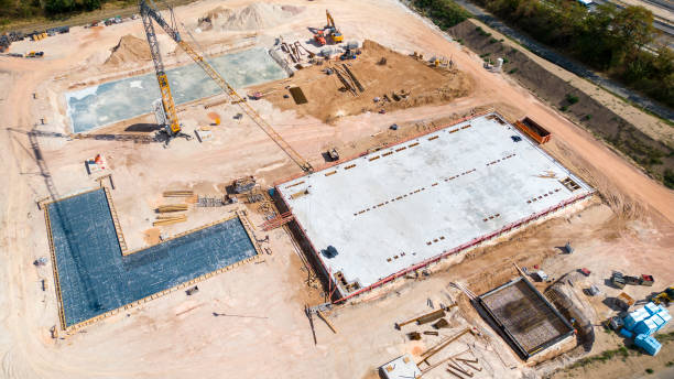 istock Large construction site, cranes and equipment - aerial view 1427598974