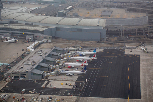 Aerial view of a group of Air Canada Rouge and United Airlines Boeing and Airbus aircrafts parked at gates at Terminal 1 at Toronto Pearson International Airport in April 2022.
