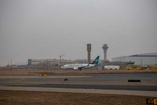 WestJet Boeing 737-7CT aircraft with registration C-GWSO taxiing at Toronto Pearson International Airport in April 2022.