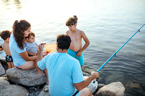 Happy family enjoying the sea fishing
