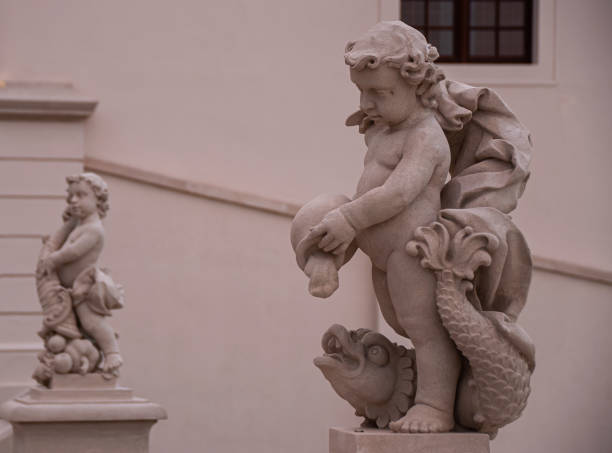 istock Baby statues of boys feeding fish 1427600068
