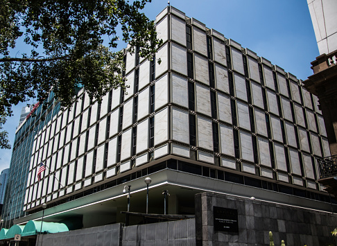 United States Embassy in Mexico City, Mexico. The building consists of white squares and is located on Ave Paseo de Reforma.