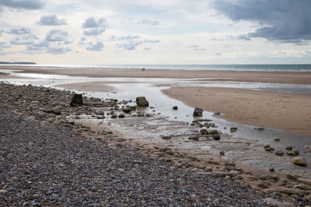 istock beach wit stones and low tide on sunny day 1427606772