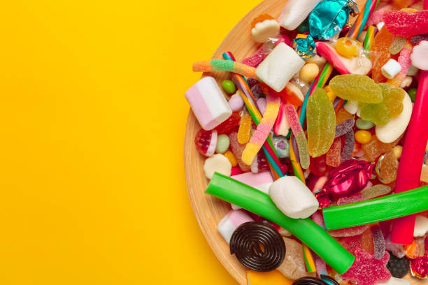 istock colored candies on yellow background 1427607696
