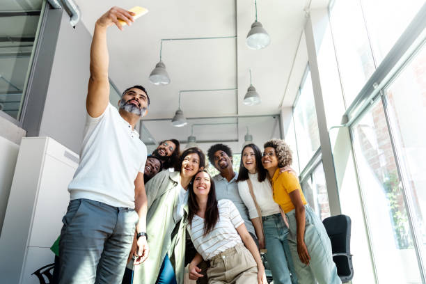 istock Happy multiracial colleagues take selfie in the office. Copy space. 1427607826