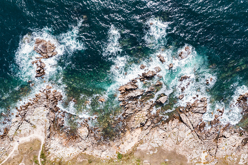Aerial landscape of ocean and rocks off the coast of France.