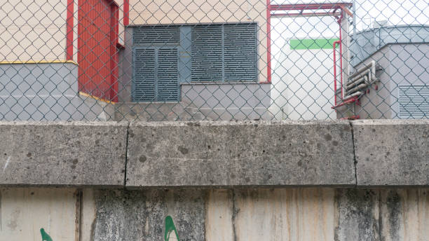 istock Industrial building behind wire fence 1427608594