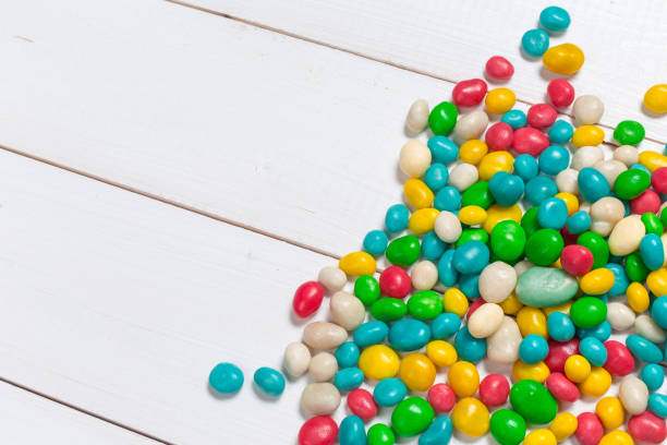 istock Colorful candies on wooden background 1427609887
