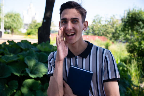 istock Young attractive student with a book. Happy man. 1427610008