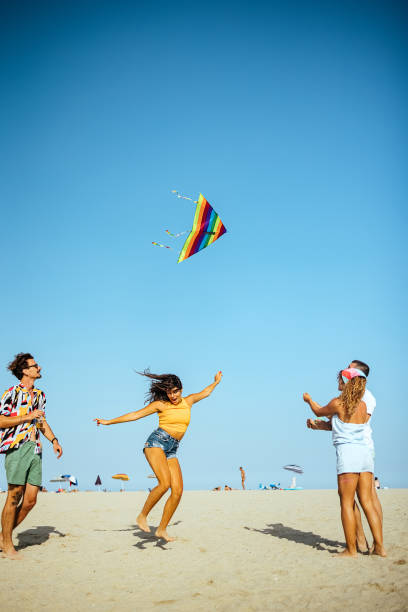 istock Young people flying kite on beach 1427610152