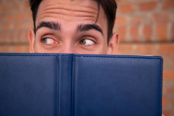 istock Young attractive student with a book. Happy man. 1427610805