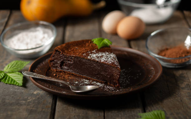 istock Chocolate pumpkin pie on a wooden background. Cooking. 1427612398
