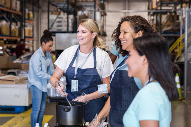 istock Diverse soup kitchen volunteers smile at unseen person 1427618069