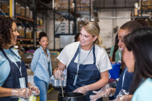 istock While serving soup for homeless, diverse women smile and chat 1427618073