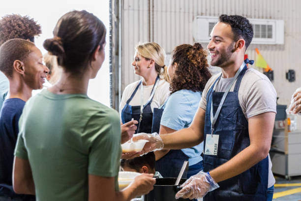 istock Cheerful, diverse volunteers serve hungry in soup kitchen 1427618121