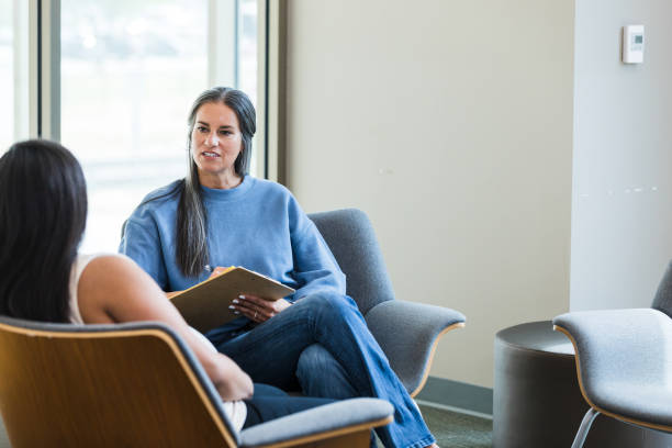 istock Mature healthcare worker asks unrecognizable pregnant client question 1427618729