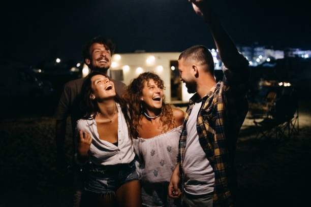 istock Friends at night on the beach with sparklers. 1427620594