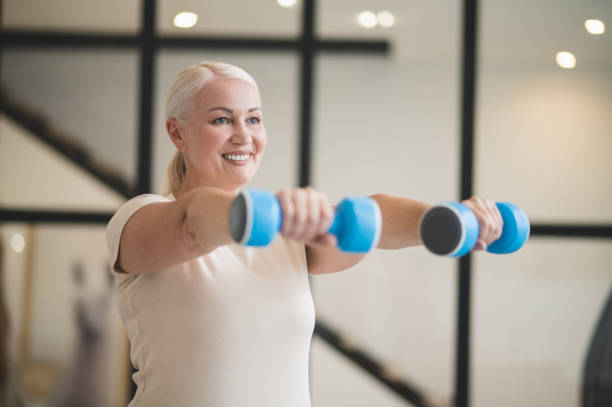istock Joyful woman working out with hand weights 1427623354