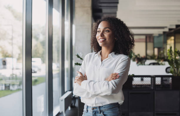 istock Young businesswoman looking at window in office 1427627794