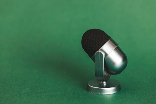 Microphone on green background.
