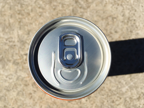 High angle view drink can on the concrete background with sunlight reflection and shadow