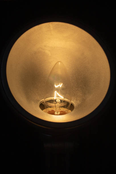 istock Circular lamp with a yellow light bulb turned on 1427633349