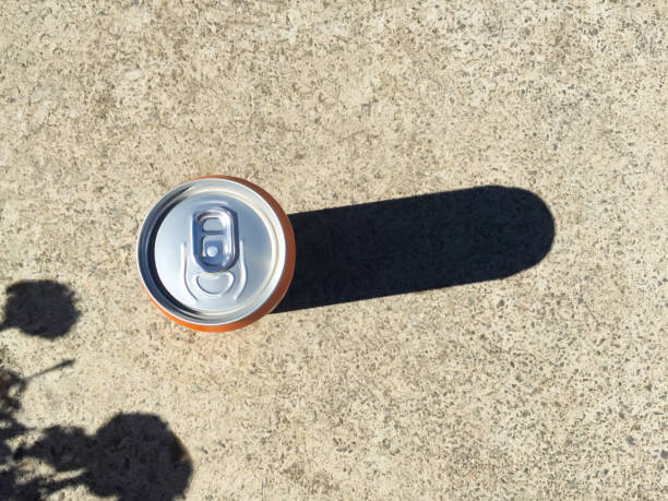 High angle view drink can on the concrete background with sunlight reflection and shadow