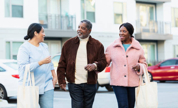 istock Senior couple and woman walking outdoors, conversing 1427633882