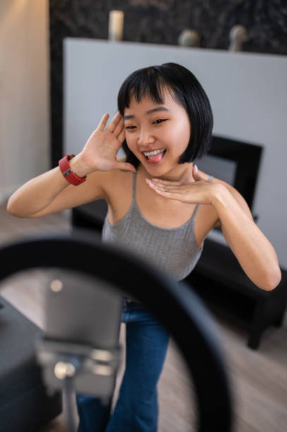 istock Mischievous girl vlogger entertaining her online audience 1427639377