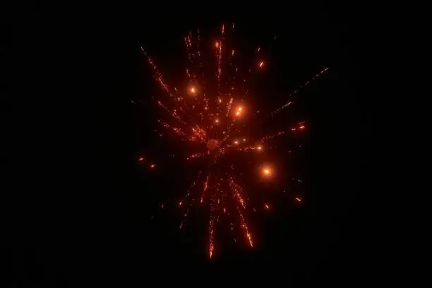 Photo of Red night fireworks bright sparkles and shiny festival explosion, glittering motion of sky fire