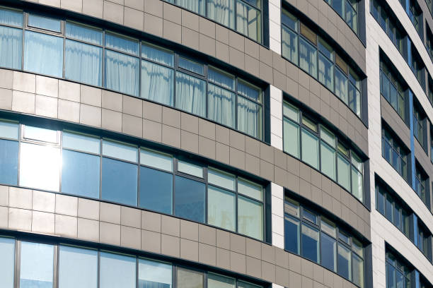 istock Close up view to office skyscraper windows, high business building windows with sunlight glare 1427639692
