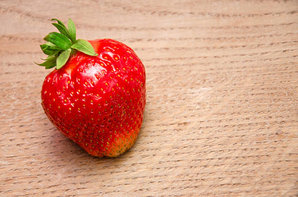 Strawberry  on a wooden background, close-up