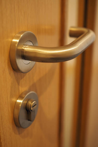istock Chrome door handle with key lock on wooden door 1427645872