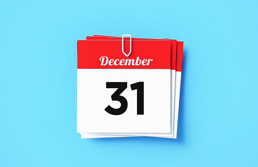 December 31 calendar sitting on blue background. Horizontal composition with copy space. Directly above. New year's eve concept.
