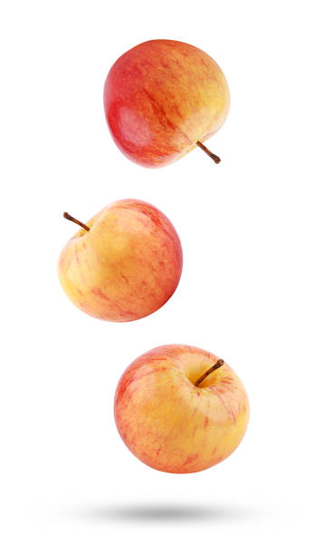 istock Whole red yellow apple falling in the air isolated on white 1427649463