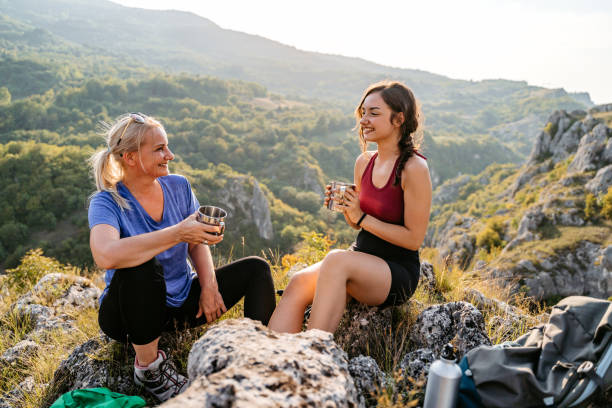 istock Mother And Daughter Drinking Coffee On The Mountain After A Hike 1427651733