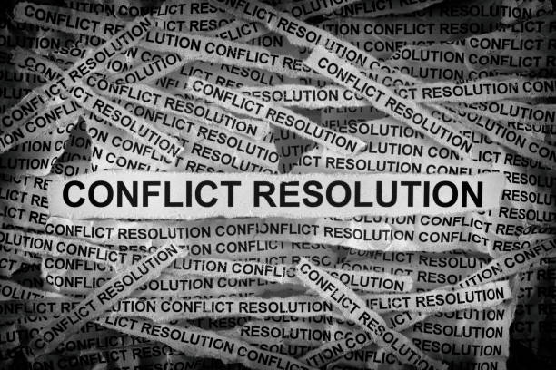 istock Strips of newspaper with the words Conflict Resolution typed on them 1427651766