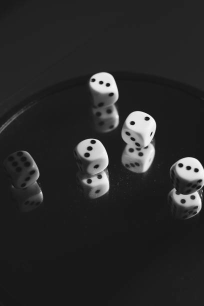 istock Playing dice on glass with reflections in it. Black and white photo 1427651886