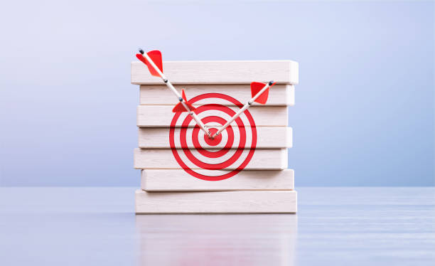 istock Arrows Hitting Red Bull's Eye Target On Wood Blocks in Front a Defocused Background 1427653655