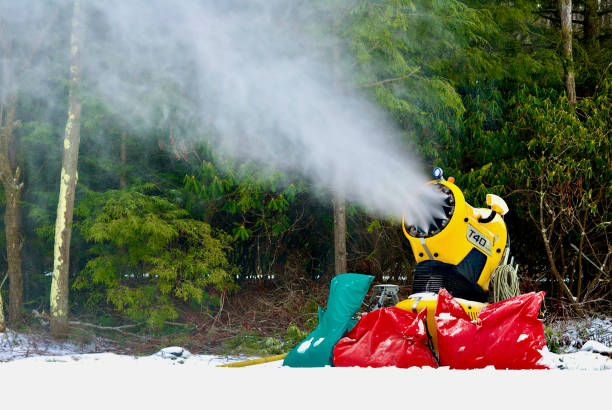 Tucker County, West Virginia, USA - January 18, 2020: A snow cannon shoots out artificial “snow” onto the sledding hill at Blackwater Falls State Park on a cold winter day.