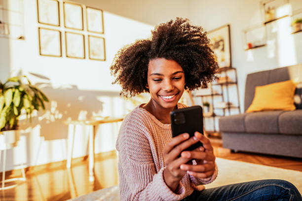 istock Young African American student using smart phone at home 1427654199