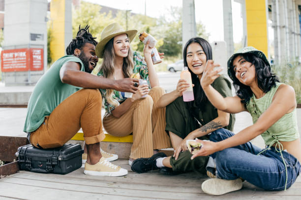 istock Group of young people having lunch break outdoors 1427655800