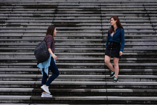 istock Two young Asian women on staircase 1427656676