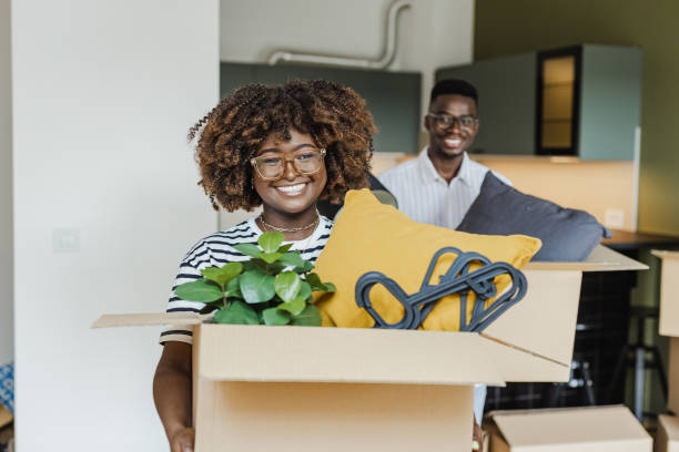 istock Couple carrying boxes into new home on moving day 1427657356