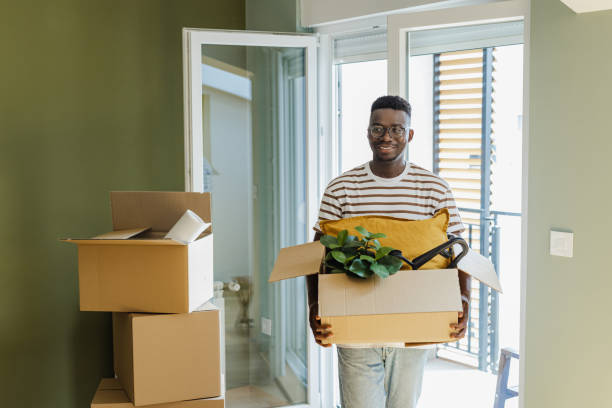 Young man moving into a new apartment stock photo