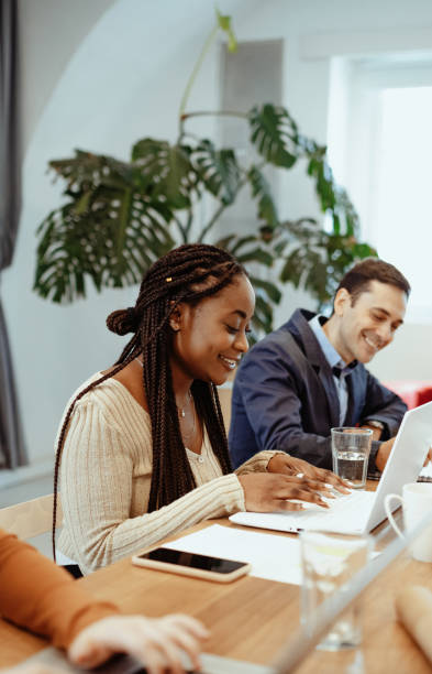 istock Multi ethnic group of entrepreneurs working in office after reopening 1427658331