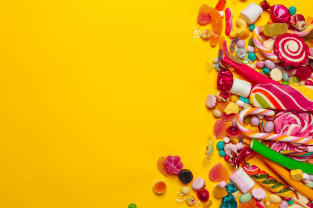 istock colored candies on yellow background 1427659023