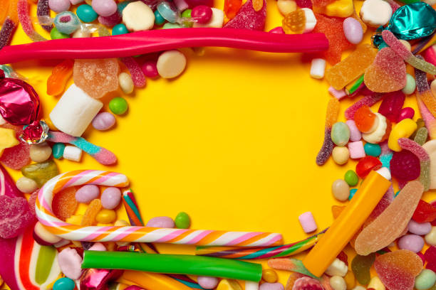 istock colored candies on yellow background 1427659026