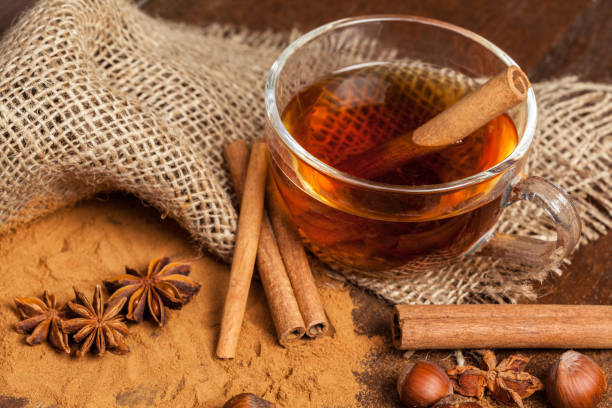 istock Cup with aromatic hot cinnamon tea on wooden table 1427659079